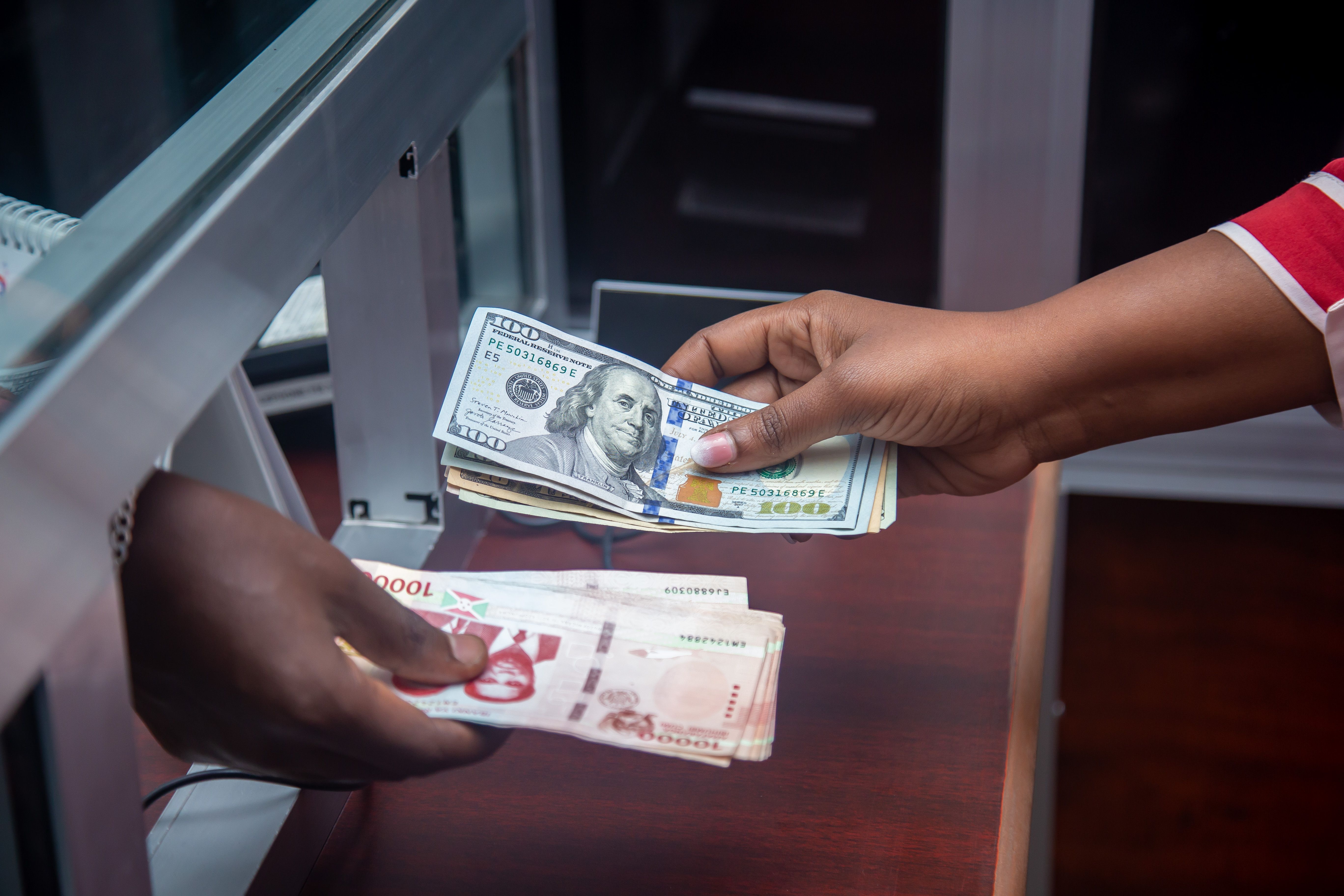 Dollars exchanged for local currency at a counter