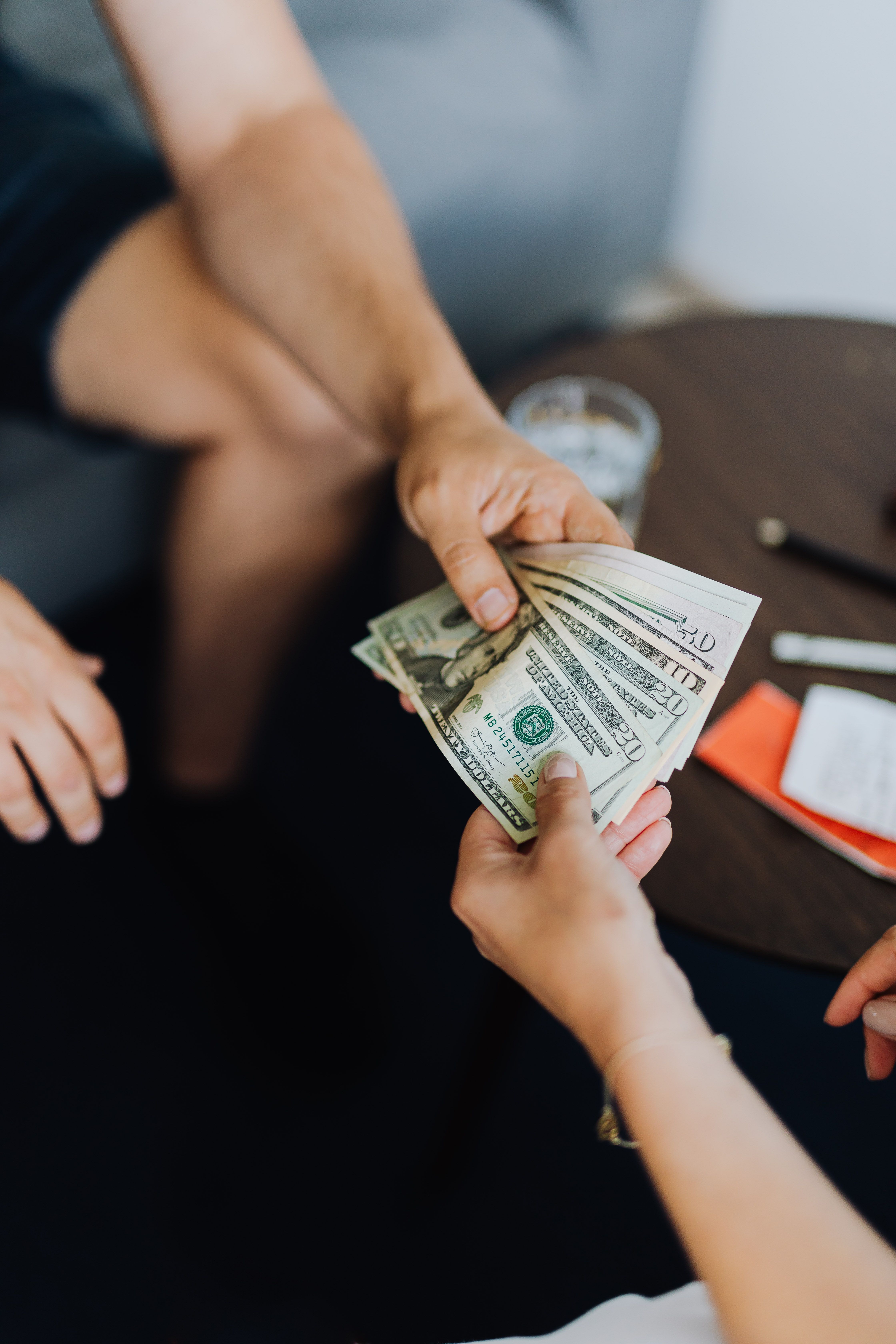Two people carefully completing a cash transaction